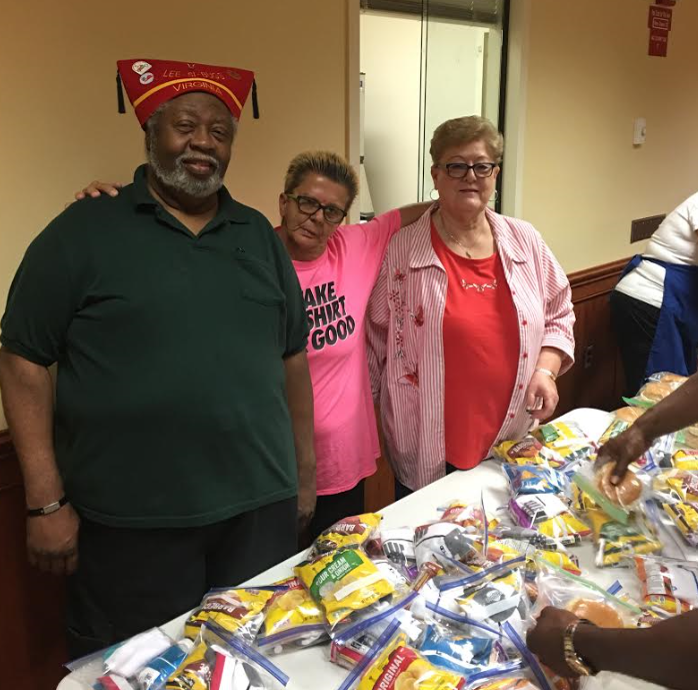 George Williams and VFW 1177 Auxiliary President Carolyn Hurd help pass out snacks.